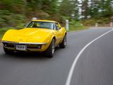 a yellow car that is driving down the road