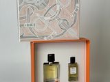 two bottles of perfume sitting in a box on top of a table