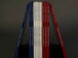 several books are stacked on top of each other on a table