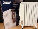 a white electric radiator sitting next to a box on a table