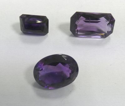 three amethtites of different shapes and sizes