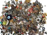 a pile of assorted jewelry on a white surface