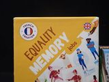 a box of equality memory cards sitting on top of a pile of books
