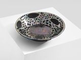 a black and white bowl sitting on top of a white box