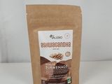 a brown bag of ground coffee sitting on top of a white table