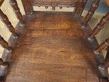 a wooden chair that is sitting on a hard wood floor
