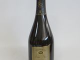 an old bottle of champagne sitting on a white surface