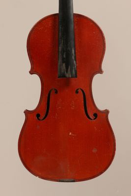 a close up of a red violin with a black bow