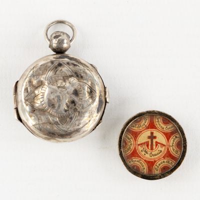 silver pocket watch with a red and white enamel picture on the front