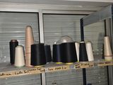 many spools of thread on a shelf in a room