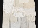 several different types of white lace on a black background