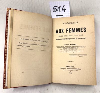 an open book on a white table with a label on it