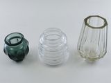 three glass vases sitting next to each other on a table