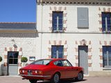 a red car that is parked in front of a building