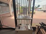 a table with a newspaper on it in front of a window