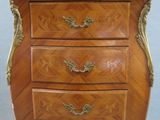 an image of a small wooden chest of drawers with marble top