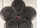 une photo d'un objet noir sur une surface blanche