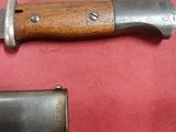 two knives are laying on a red surface next to each other