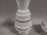 two white vases sitting next to each other on a table