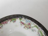 a plate with a floral design on it sitting on a table