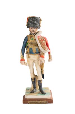figurine of a soldier with a hat and uniform on a base