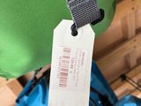 a green bag with a tag hanging from it ' s side
