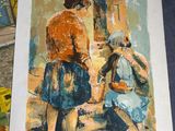 un tableau représentant une femme et un enfant posé sur une table
