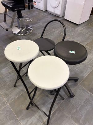 three stools that are sitting on a tile floor