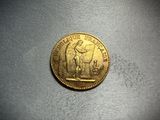 a close up of a gold coin with a woman on it