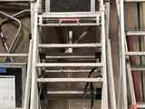 a ladder that is next to a wall with a computer on it