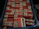 a person holding a box full of red and white boxes