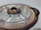 a glass plate with a wooden lid on a table