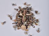 a pile of screws and nails on a white surface