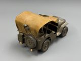 an old toy truck with a canvas bag on the back of it