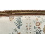 a close up of a couch with a floral pattern on it
