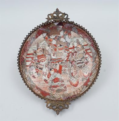 an image of a decorative plate with a picture of people on it