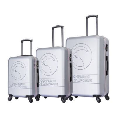 three pieces of luggage sitting on top of each other on a white surface