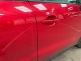 a red car that is parked in a garage