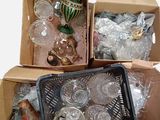two boxes with glass items in them sitting on a table