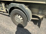 an image of a flatbed truck with a flat tire