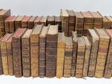 a lot of old books stacked on top of each other