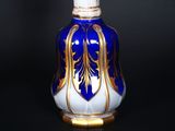 a blue and white vase with gold decoration on it