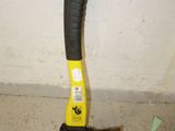 a large black and yellow hammer on the floor