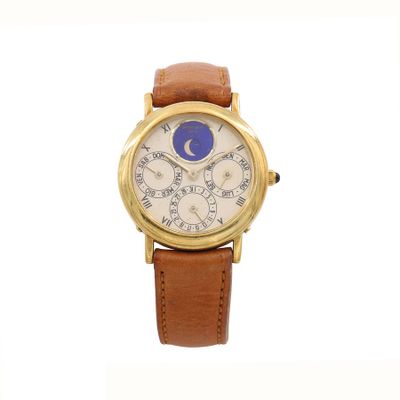 an image of a gold wrist watch with a blue moon on the face