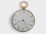 a gold pocket watch with roman numerals on the face