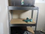 a shelf that has some tools on it in a room