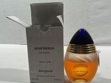 an image of a bottle of perfume sitting next to a box