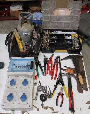 a table with tools and tools on it in a garage