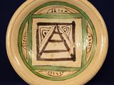 a green and white plate with a triangle on it