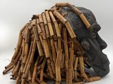 a close up of a pile of sticks with a face on it